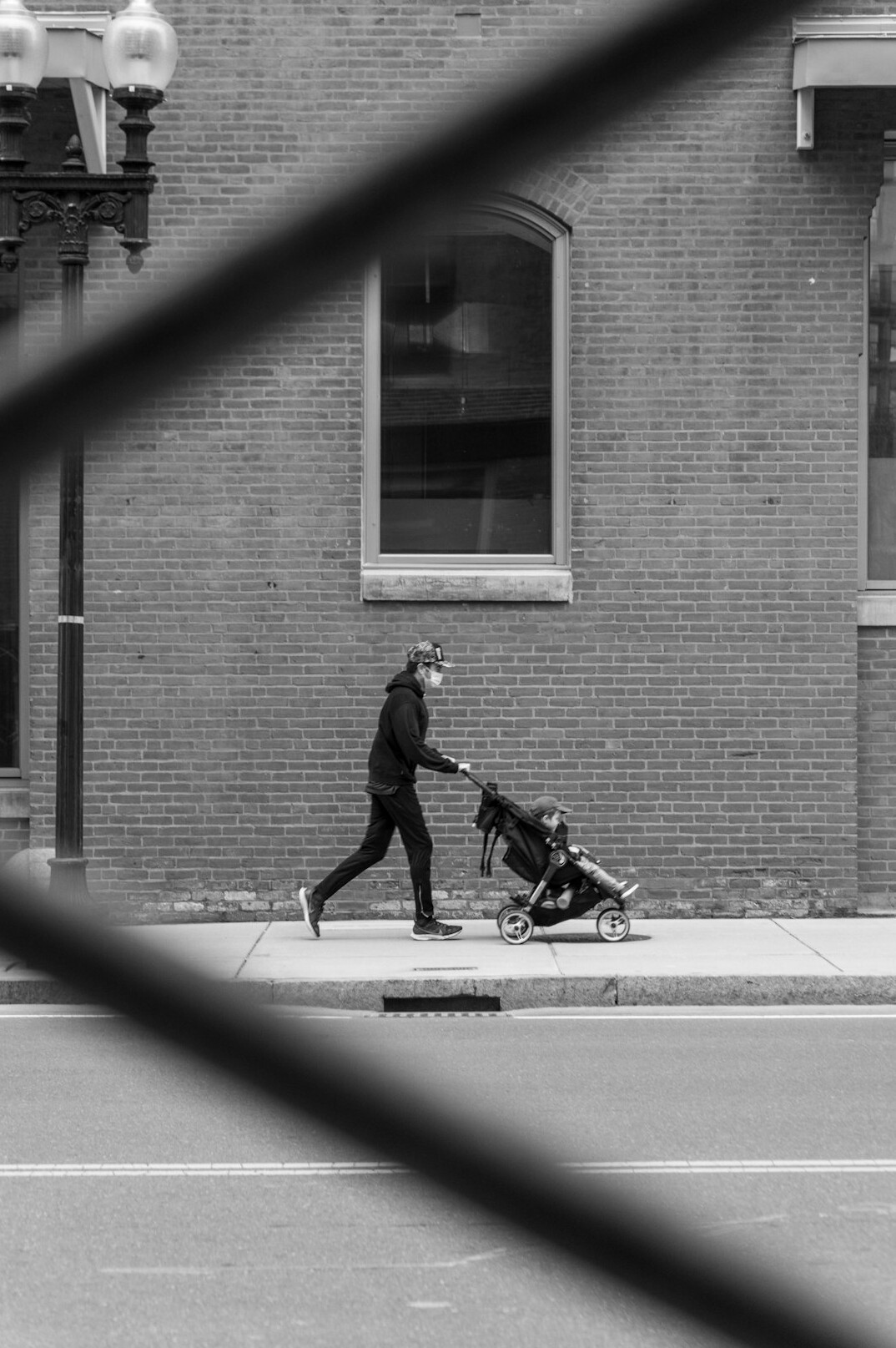 mother pushing stroller in city